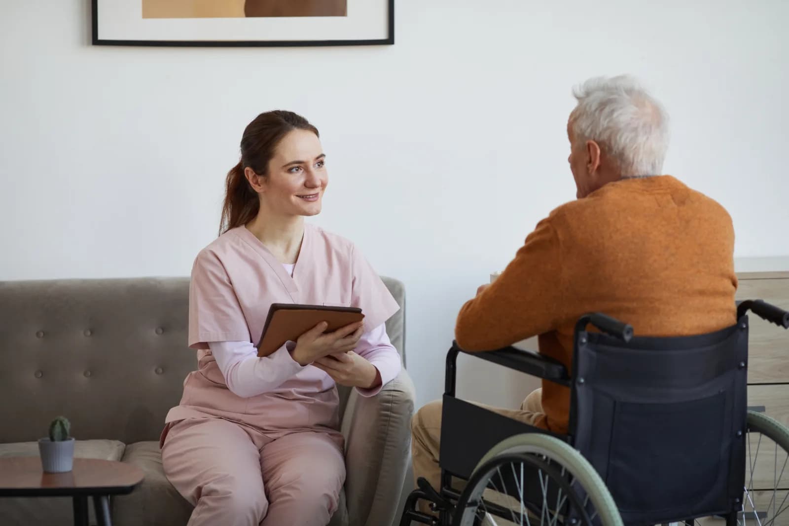 Nurse talking to patient in wheelchair