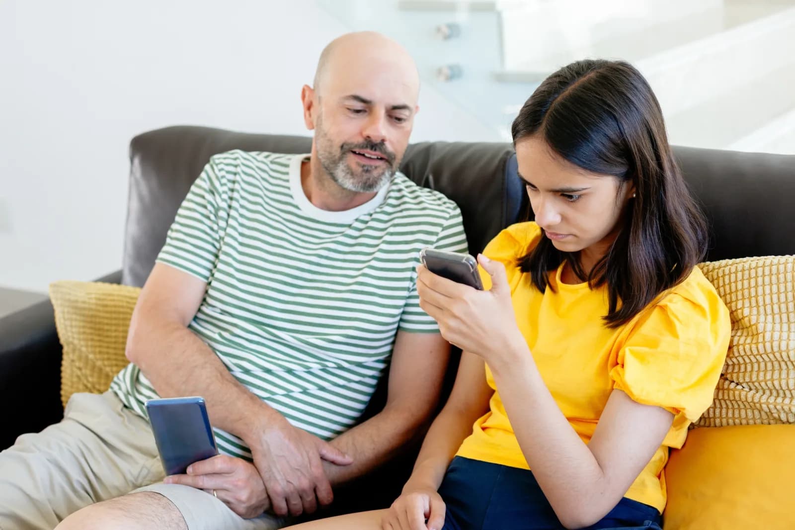 Father and daughter looking at mobile phone