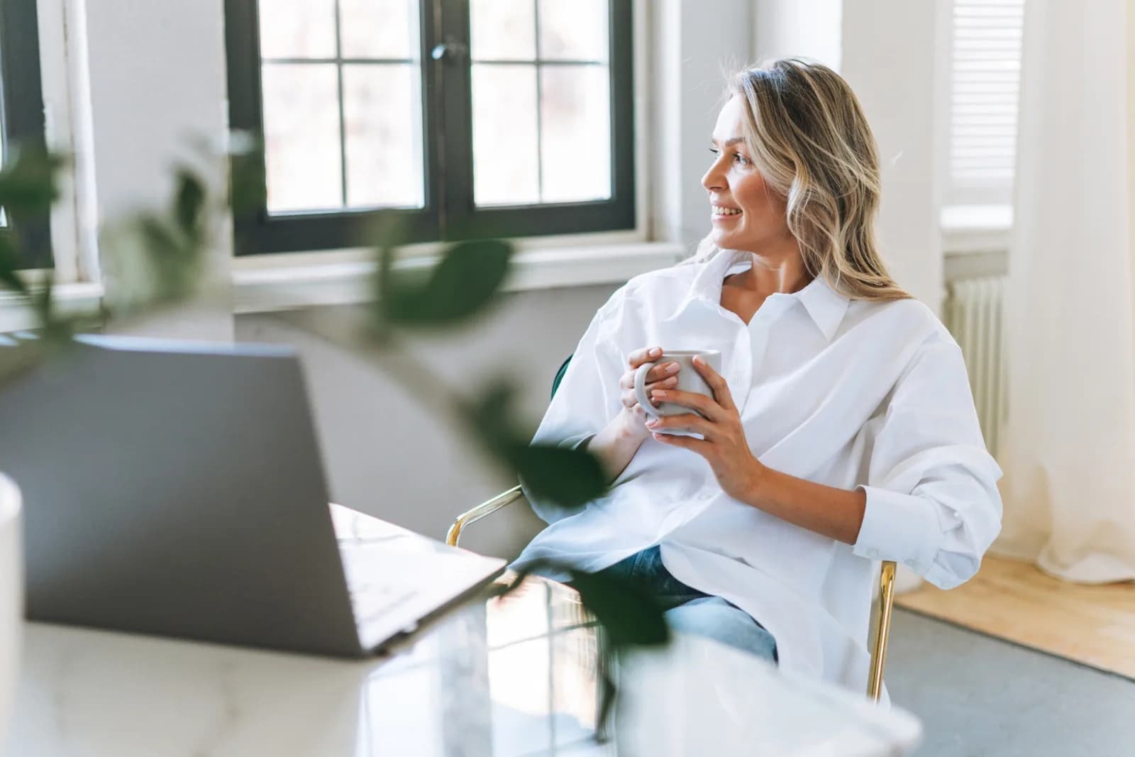 Woman relaxing in chair holding coffee