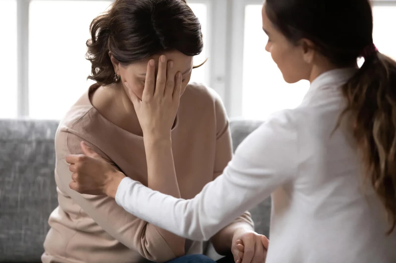 Doctor comforting upset patient