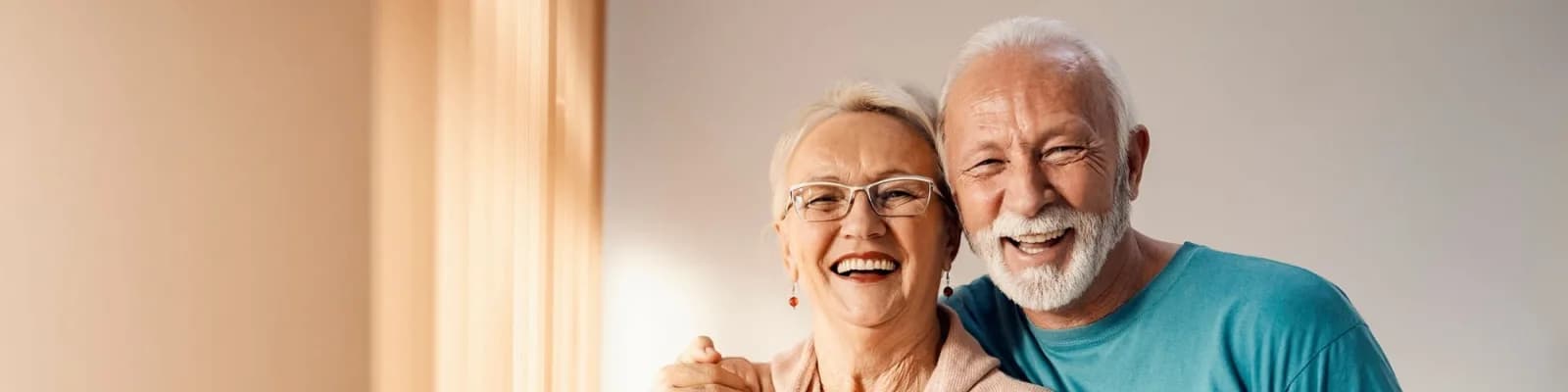 Senior couple smiling and embracing