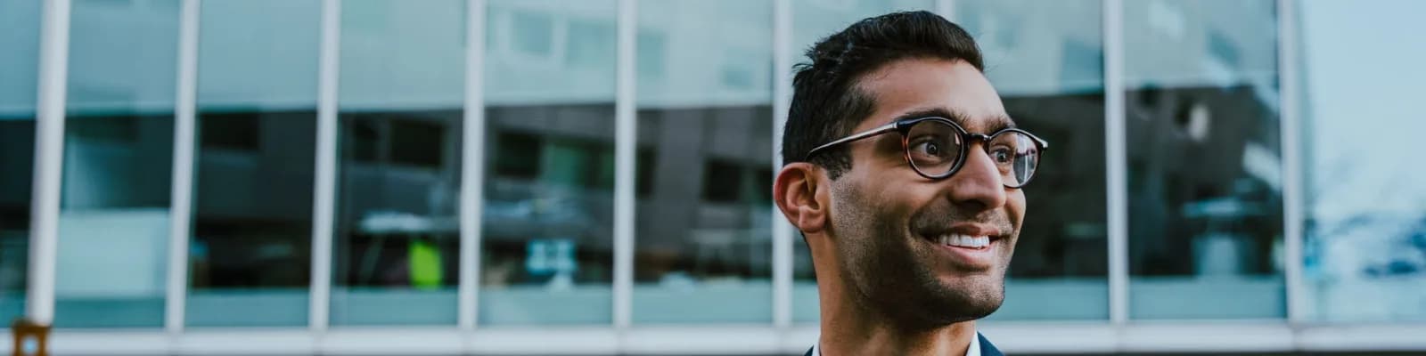 Ethnic businessman outside office buildings